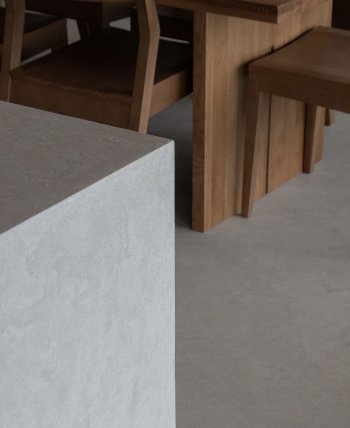 Microcement volume beside solid oak furniture